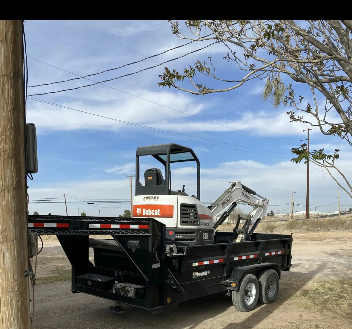 Mini excavator loaded on the gooseneck dump trailer
